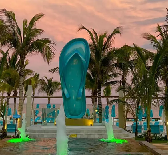 typical Margaritaville Island Reserve Riviera Maya flip flop surrounded by a water feature