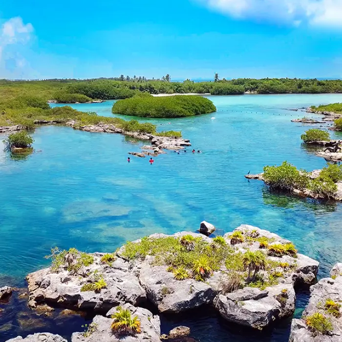 Aerial view of a beautiful lagoon and lush greenery, showing one of the main snorkeling locations on the tour