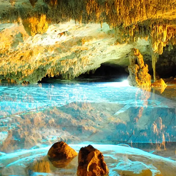 Stunning crystal-clear water inside a sacred cenote cave, one of the highlights of the Mayan Adventure Snorkeling Tour