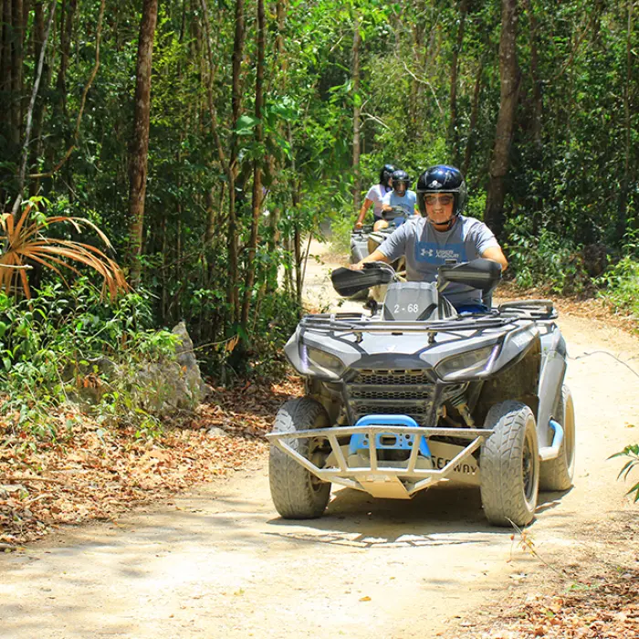 Group sharing an ATV ride through the jungle as part of a Tulum adventure