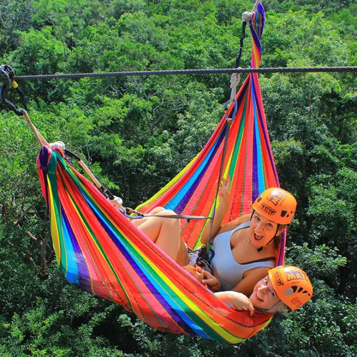 Couple gliding through the jungle on a hammock zipline for two