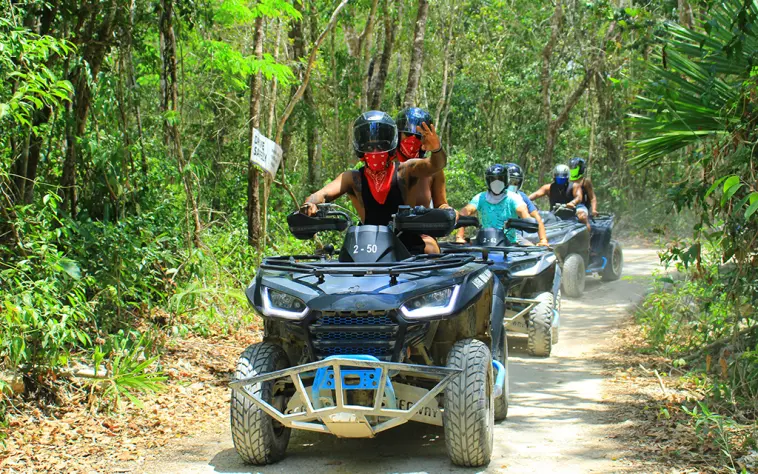 Group riding ATVs on a guided adventure deep in the Mayan jungle