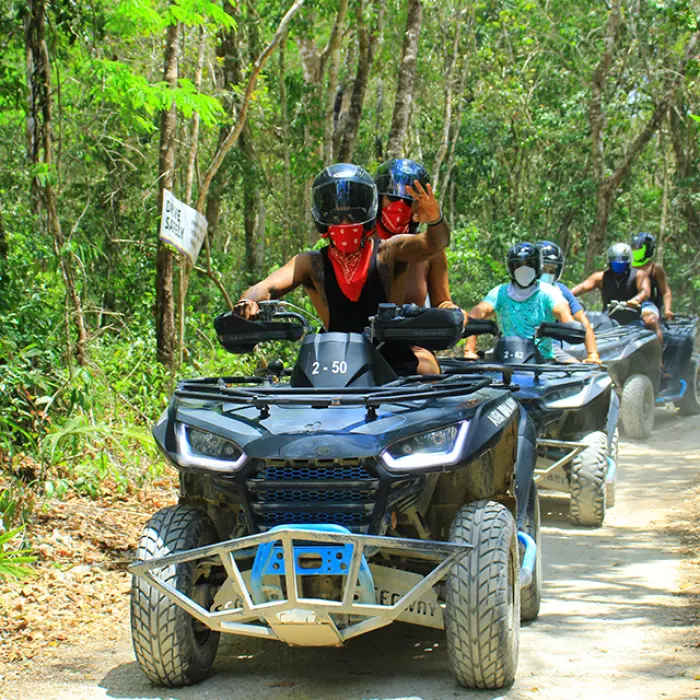 Group riding ATVs on a guided adventure deep in the Mayan jungle