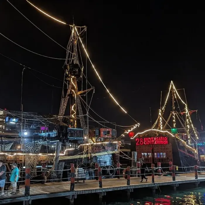 Captain Hook Cancun anniversary ship at the dock at night