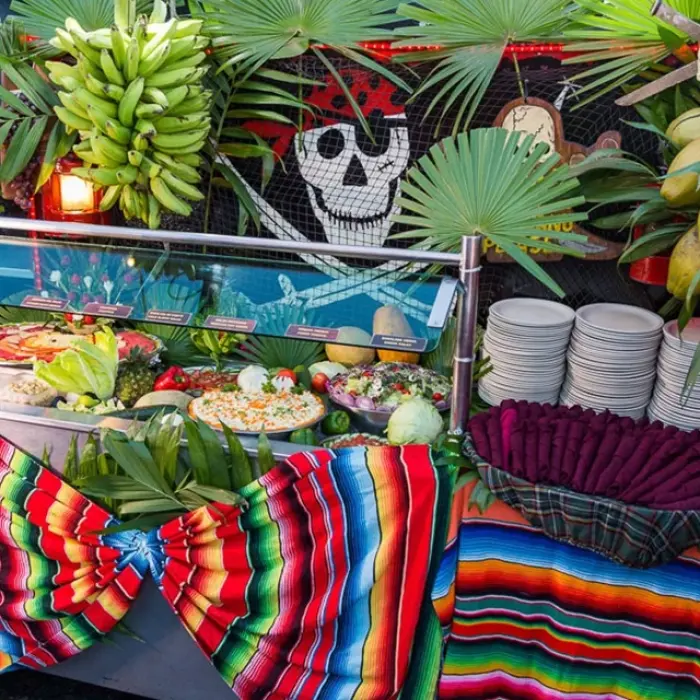Captain Hook Cancun food buffet, showcasing a variety of dishes and a colorful serape