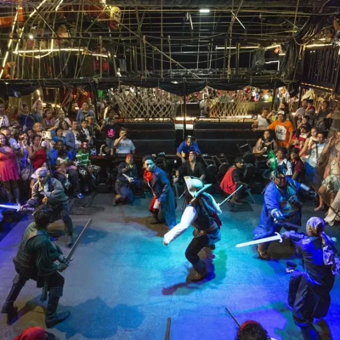 Captain Hook Cancun pirate fight, showing two pirates engaged in a sword fight during the dinner show