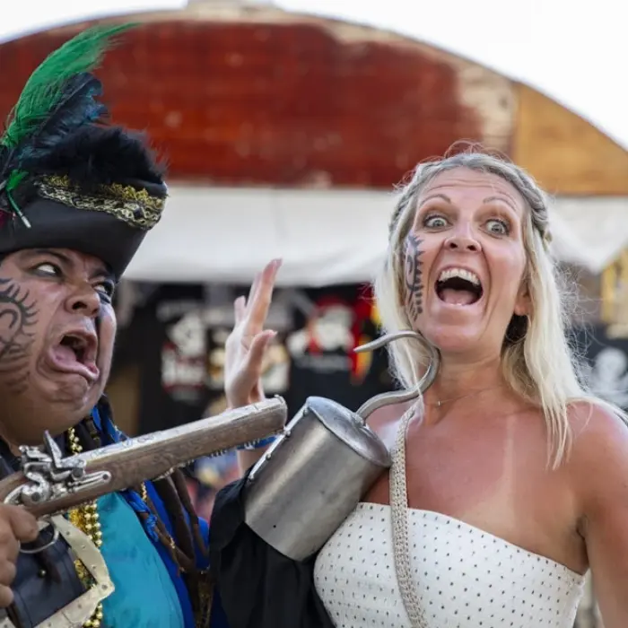 Captain Hook Cancun pirate with gun, posing with a woman