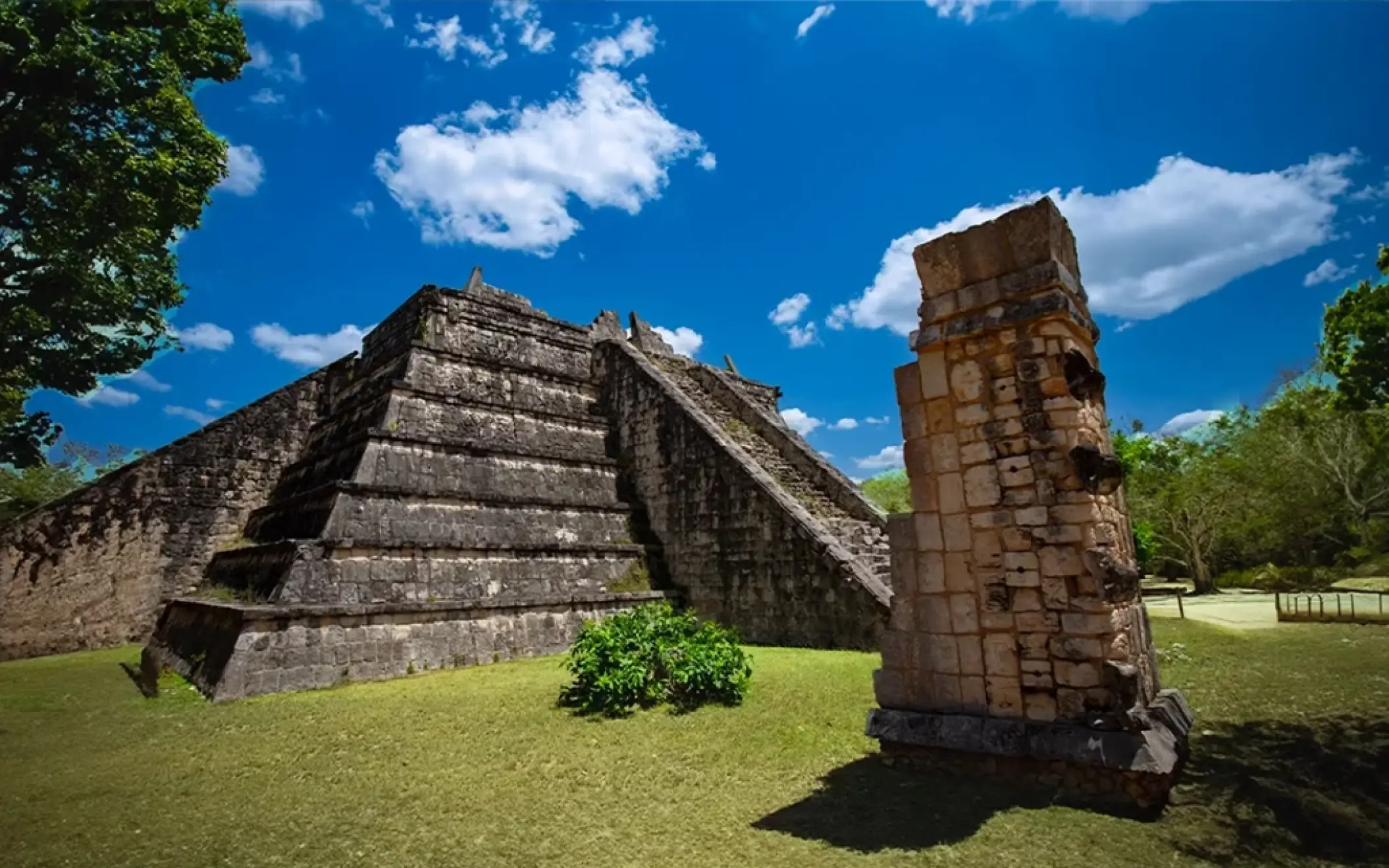 A detailed view of El Osario at Chichen Itza, highlighting its intricate stone carvings.