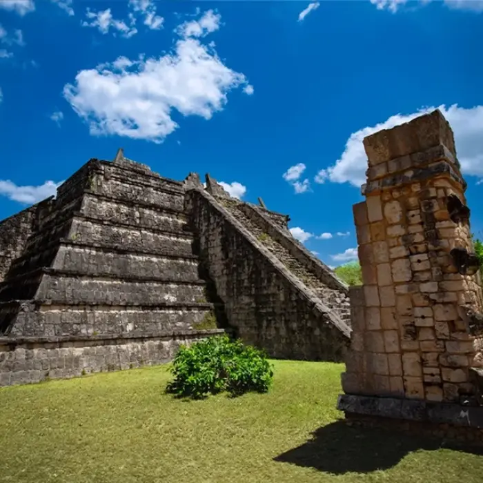 A detailed view of El Osario at Chichen Itza, highlighting its intricate stone carvings.
