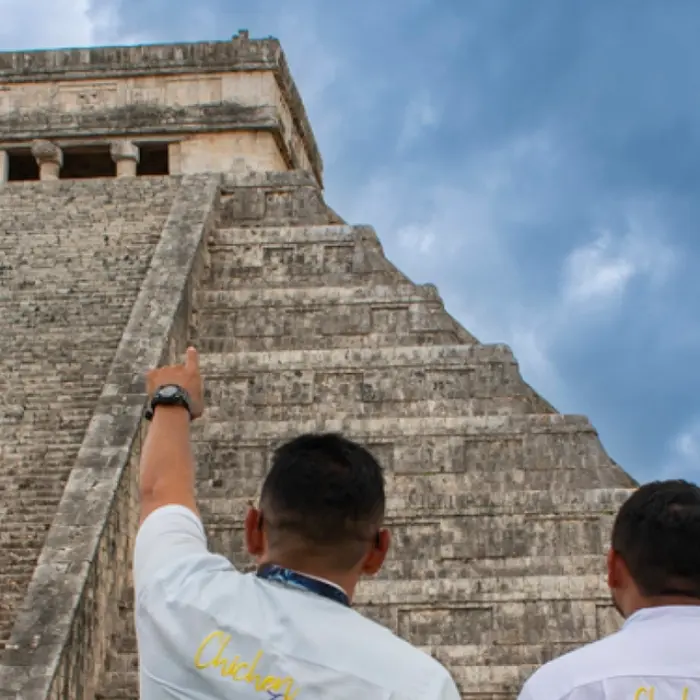 Knowledgeable tour guides at Chichen Itza, explaining the ancient site's history and significance.