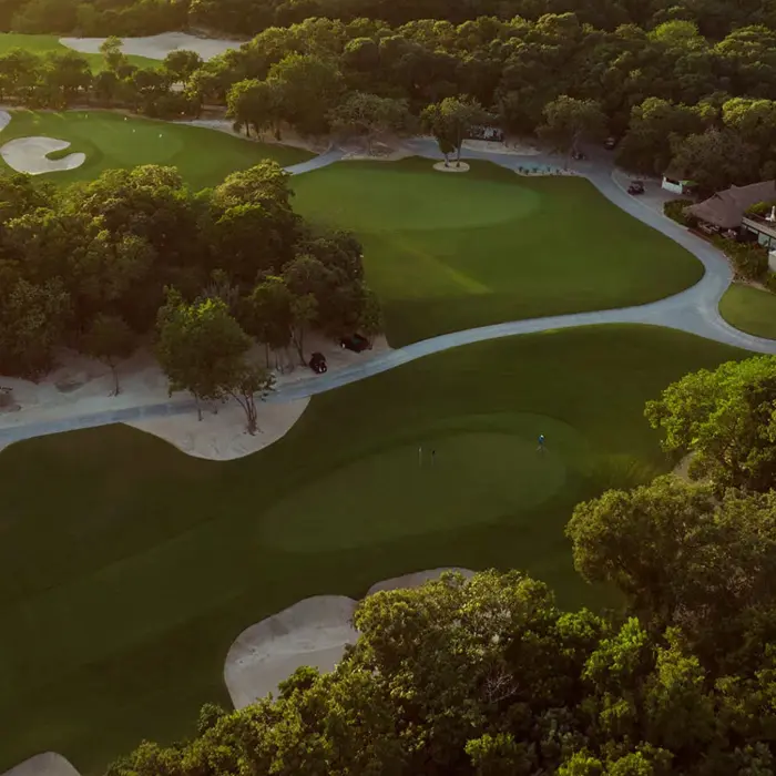 An aerial view of the luxury resort community surrounding the impeccably maintained championship golf greens of El Camaleón.