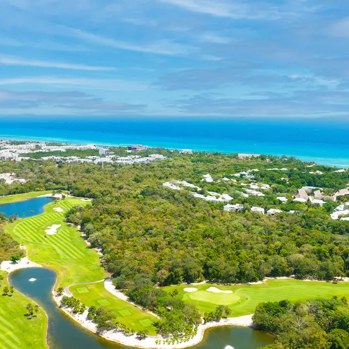 Stunning aerial view of Gran Coyote Golf Club showing lush jungle fairways just minutes from the Caribbean Sea in Playa del Carmen.