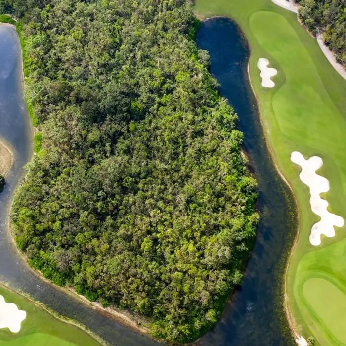An aerial view of the lush native jungle and large freshwater lakes bordering the green fairways at Gran Coyote Golf Club.
