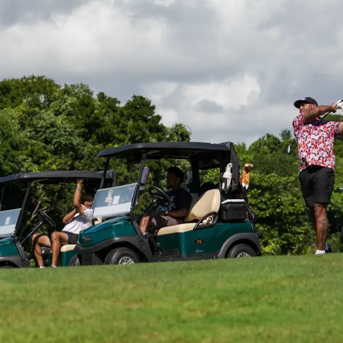 A group of friends play a relaxed round of golf with their carts parked on the fairway at Gran Coyote.