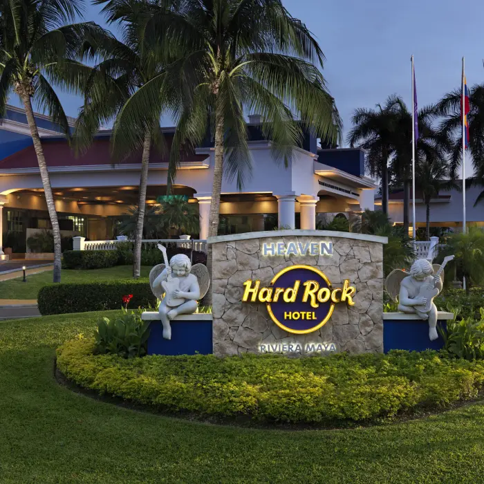 The luxurious entrance to the Heaven section at Hard Rock Hotel Riviera Maya, featuring a signature rock-and-roll sign.