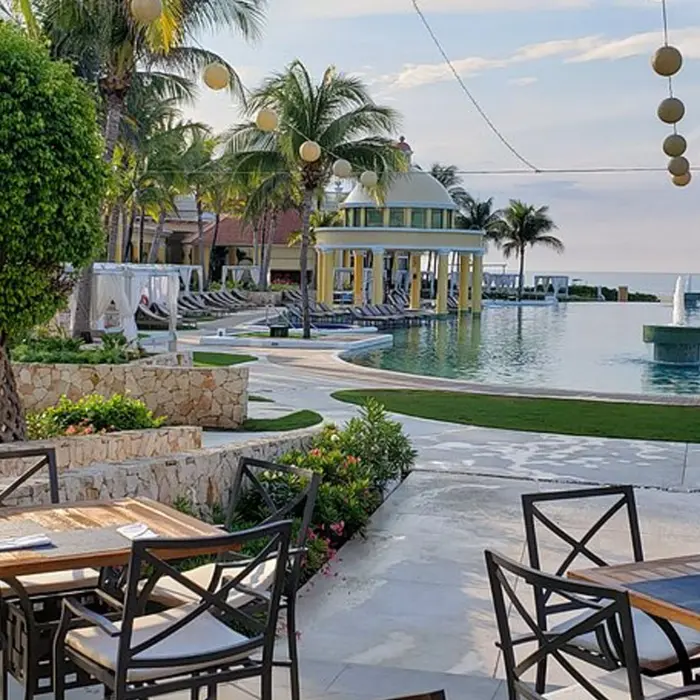 The luxurious outdoor pool, cabanas, and patio dining area near the clubhouse at Iberostar Golf Club in Riviera Maya