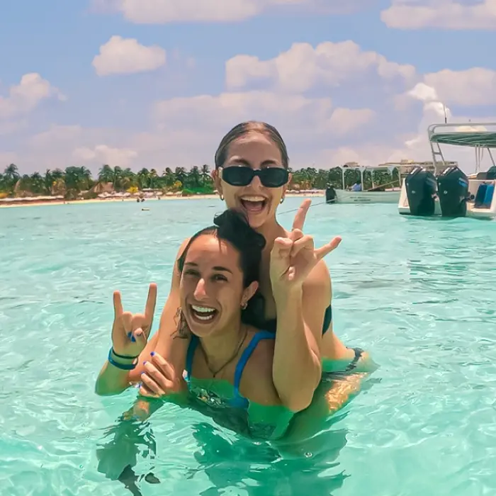 Two friends enjoying the shallow waters of Isla Mujeres on the Paradise Islands tour