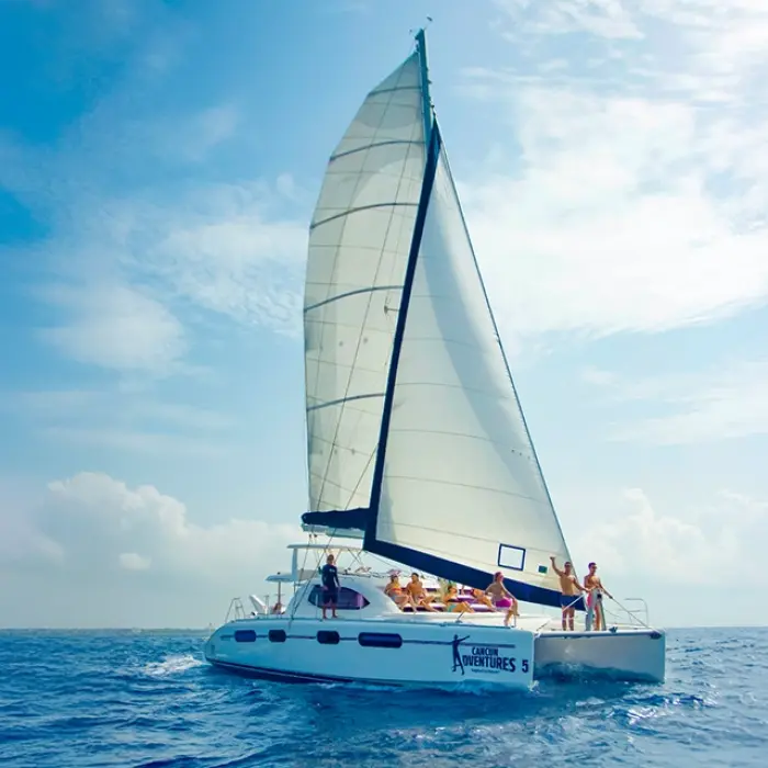 Luxury catamaran sailing and snorkeling tour in the Riviera Maya, offering a premium Caribbean experience with an open bar, gourmet lunch, and water activities like snorkeling at Inah Reef and paddleboarding. Enjoy breathtaking views, crystal-clear waters, and top-tier amenities on this all-inclusive catamaran adventure
