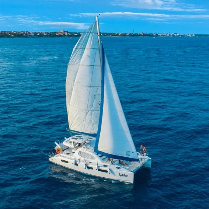 White catamaran sailing on the deep blue ocean under a clear sky