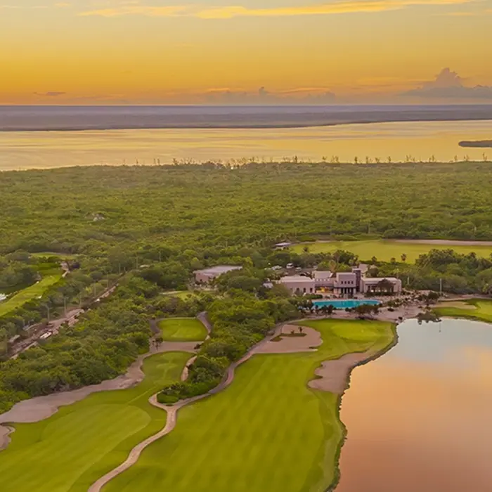A beautiful sunset view over the luxury clubhouse and tranquil lakes at the championship Playa Mujeres Golf Club in Cancún