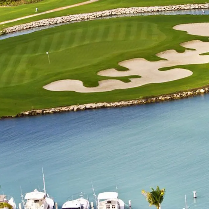 An incredible island green surrounded by the crystal clear waters of the Caribbean Sea and luxury marina.