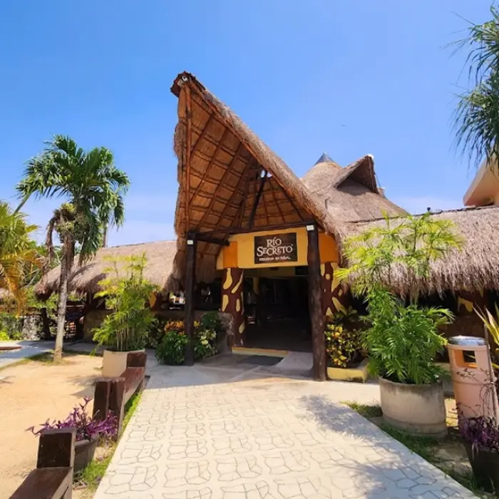 Rio Secreto entrance: Exterior view of the Rio Secreto entrance with its distinctive thatched roof and signage