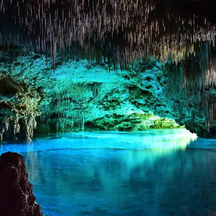 Rio Secreto illuminated cave: Stunning view of an underground cave system in Rio Secreto with turquoise water and illuminated rock formations