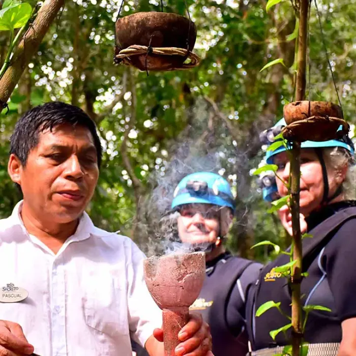 Rio Secreto Mayan ritual: Tour guide performing a traditional Mayan cleansing ritual with copal incense for visitors
