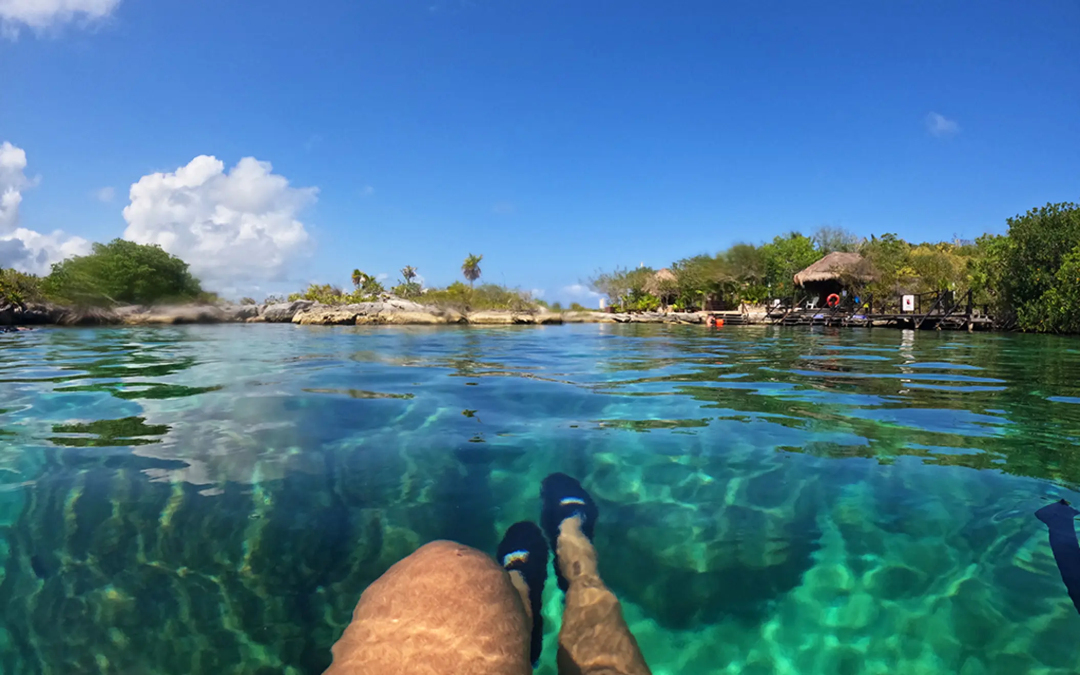 Tourist floating in turquoise water, enjoying the lagoon at a nature park in Mexico
