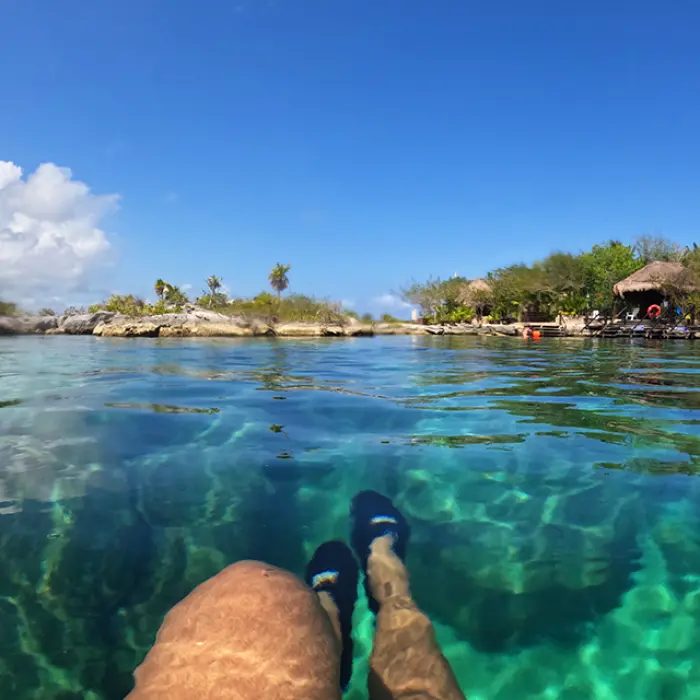 Tourist floating in turquoise water, enjoying the lagoon at a nature park in Mexico