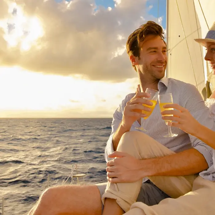 Couple enjoying drinks on a sailboat during a sunset sail in Playa del Carmen