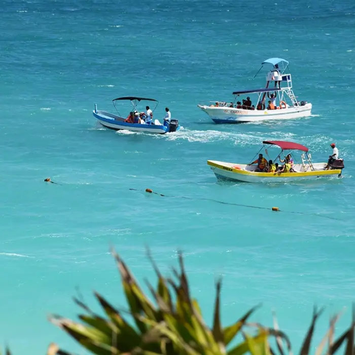Boats anchored near a coral reef in the blue Caribbean waters