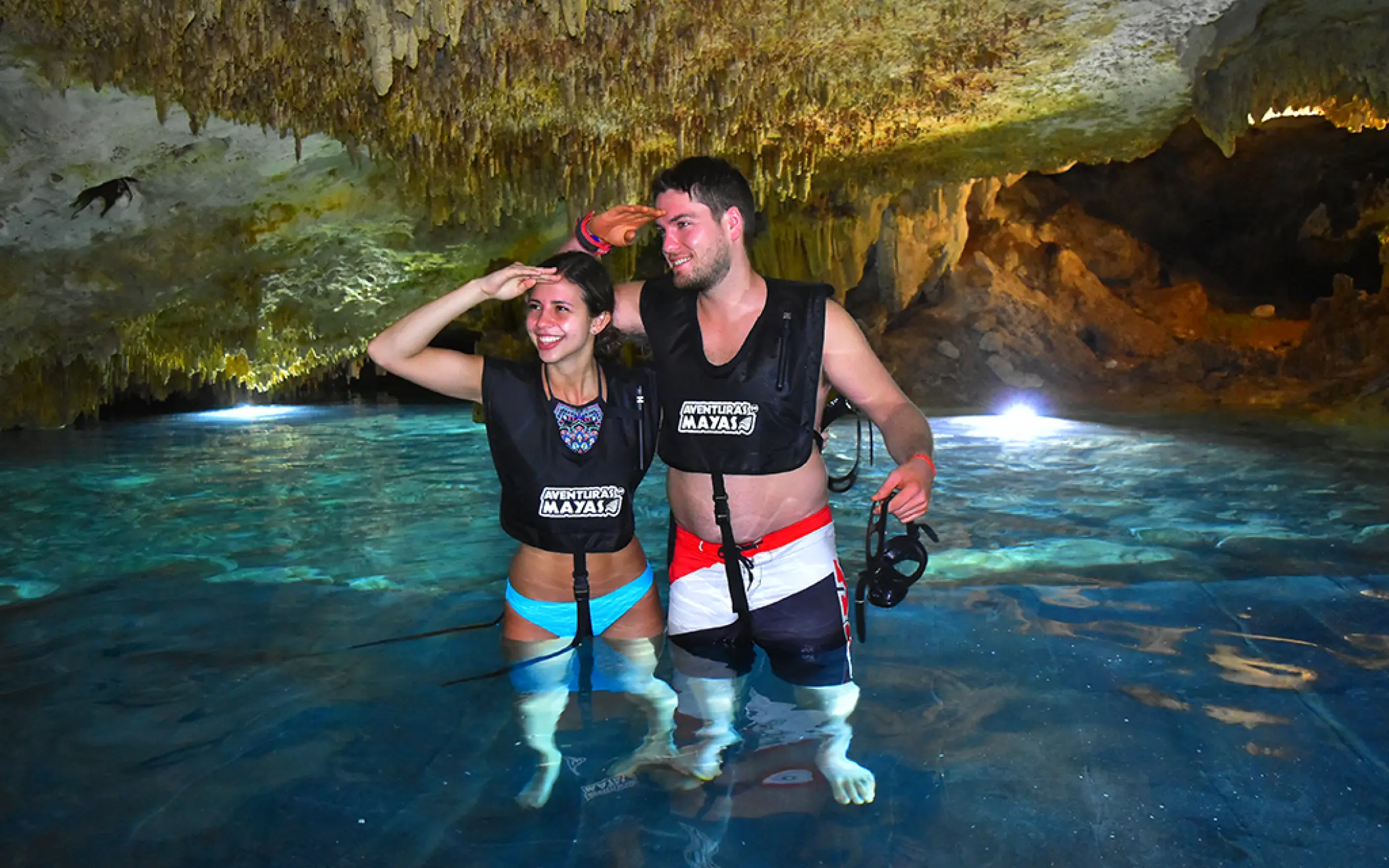 Happy couple cooling off inside a magical cenote, part of the Tulum snorkeling experience
