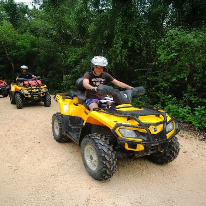 A group on an ATV tour enjoying a scenic jungle path during their Tulum experience