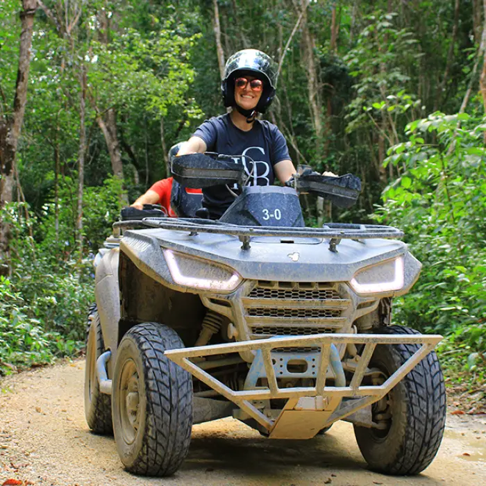 Adventurous solo rider cruising through the wild jungle paths on an ATV