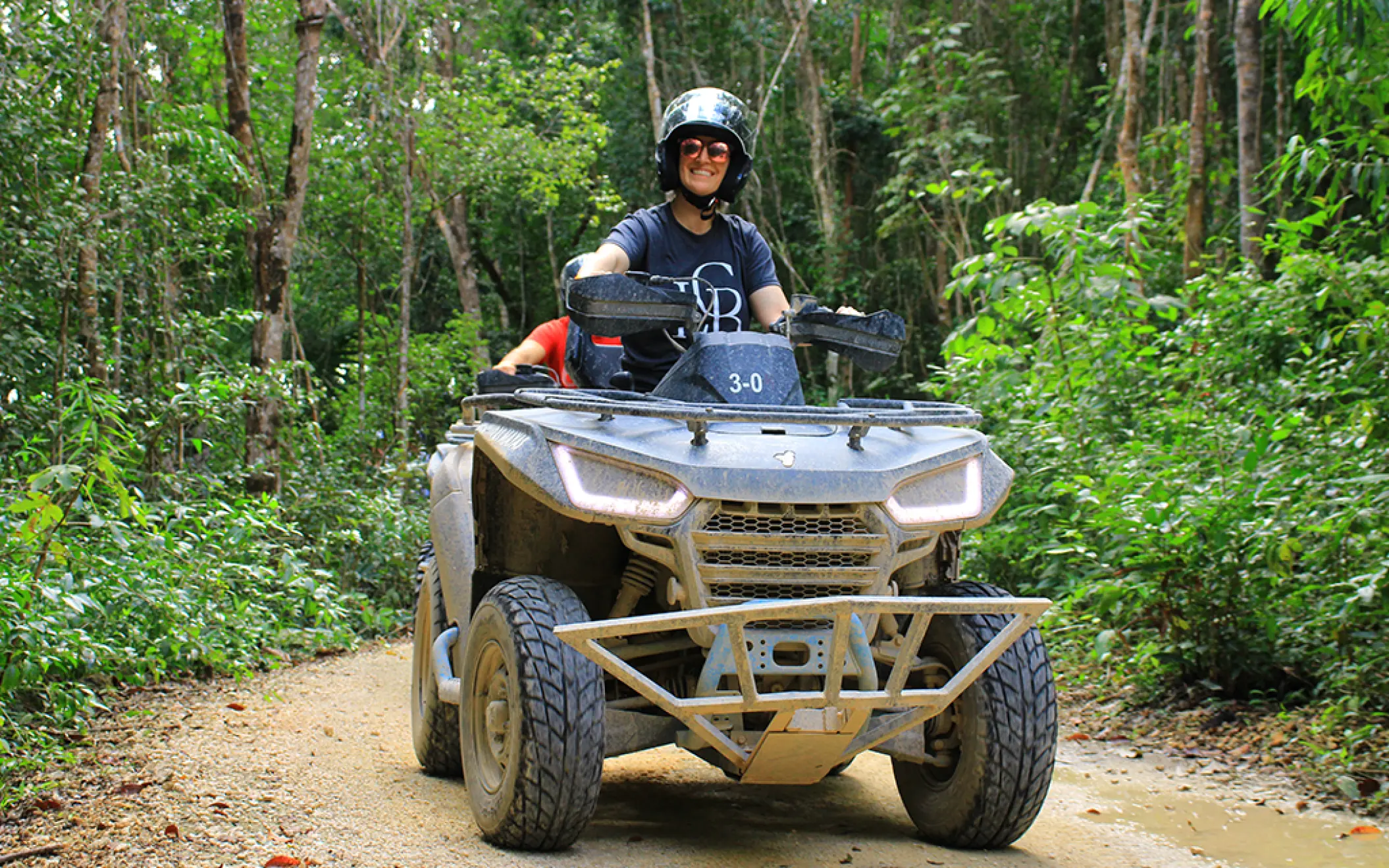 Adventurous solo rider cruising through the wild jungle paths on an ATV