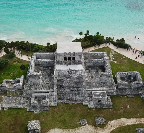 Breathtaking aerial view of the ancient Mayan ruins overlooking the turquoise Caribbean Sea in Tulum