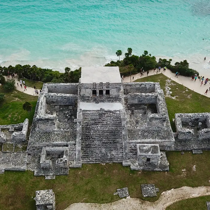 Breathtaking aerial view of the ancient Mayan ruins overlooking the turquoise Caribbean Sea in Tulum