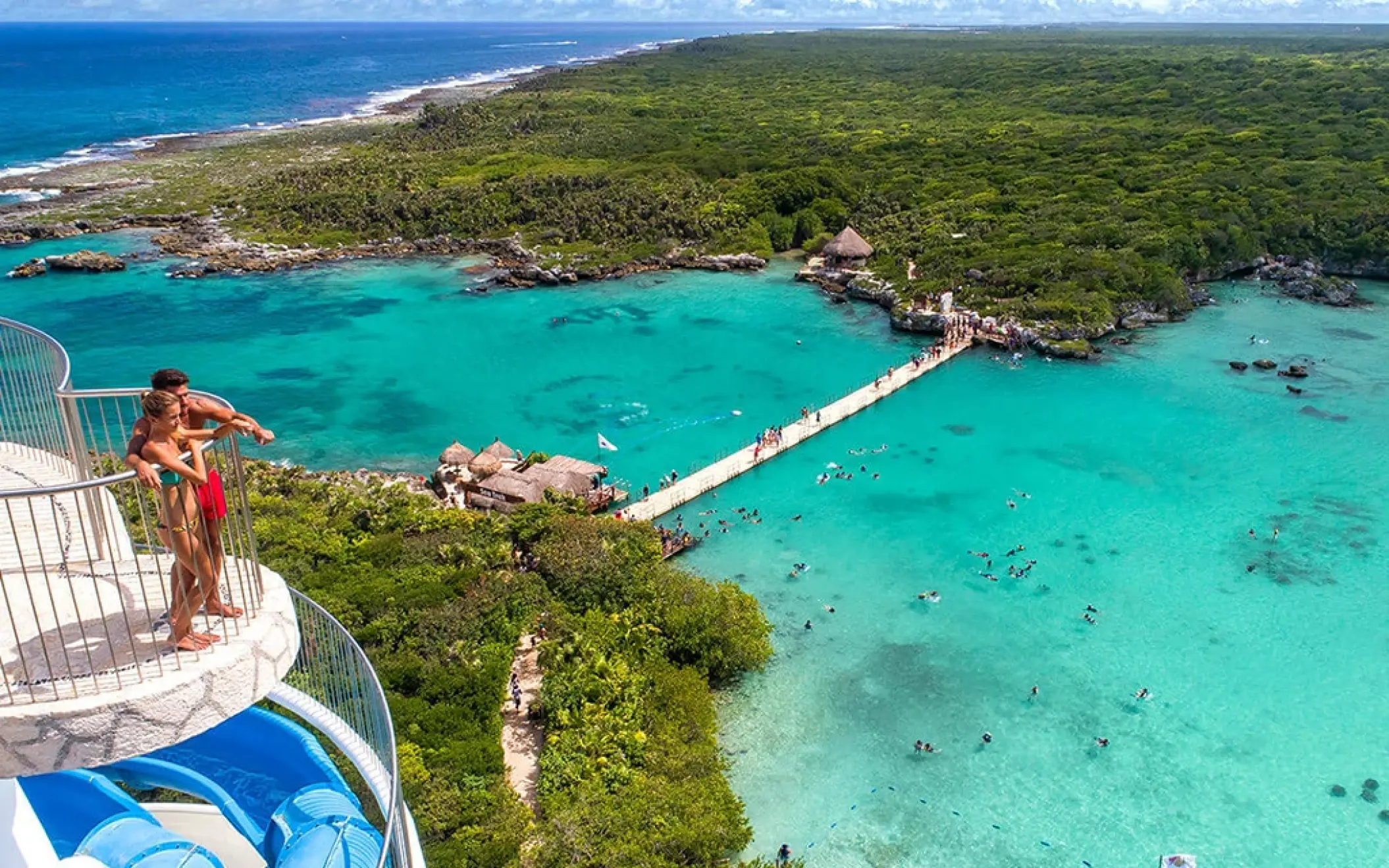 Couple enjoying the ocean view from the top of the spiral lighthouse slide at Xel-Há