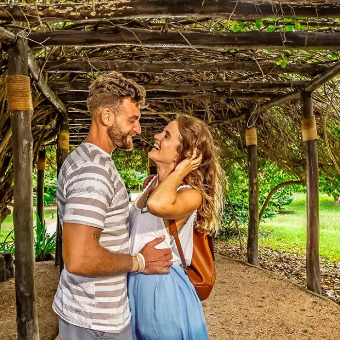 Sweet moment under a vine-covered arch at Tulum. Romantic vibes in the Riviera Maya