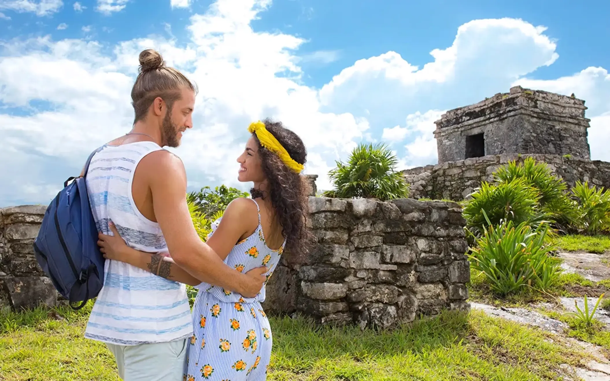 Couple exploring the ancient Mayan ruins of Tulum. Discover history in a breathtaking setting
