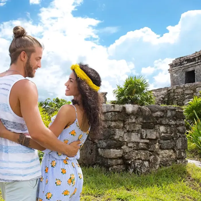 Couple exploring the ancient Mayan ruins of Tulum. Discover history in a breathtaking setting