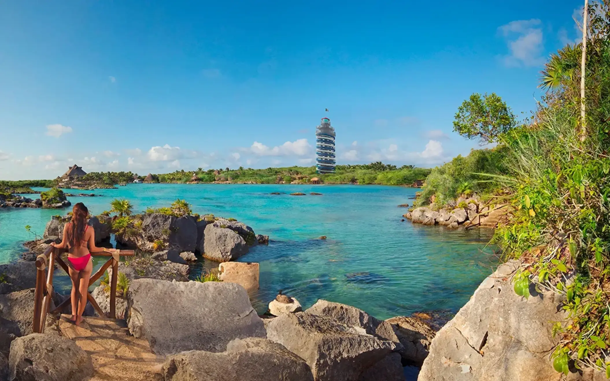Scenic view of the Xel-Há inlet with people relaxing by the clear turquoise water