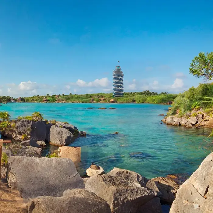 Scenic view of the Xel-Há inlet with people relaxing by the clear turquoise water