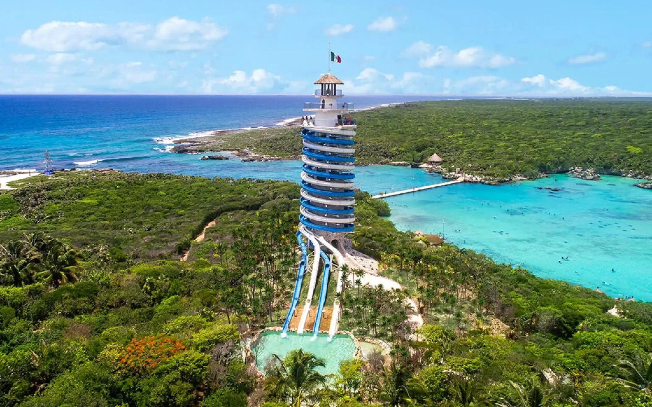 Aerial view of Xel-Há’s iconic scenic lighthouse slide surrounded by lush jungle and turquoise waters