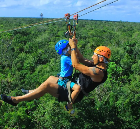 Zipline structure with safety harnesses and lush greenery in the background, available on the Tulum Xtreme Tour