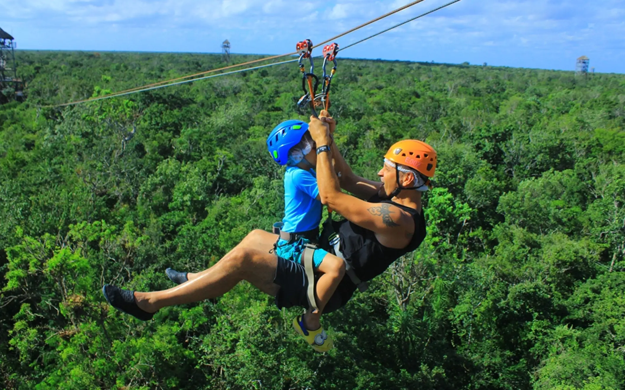Zipline structure with safety harnesses and lush greenery in the background, available on the Tulum Xtreme Tour