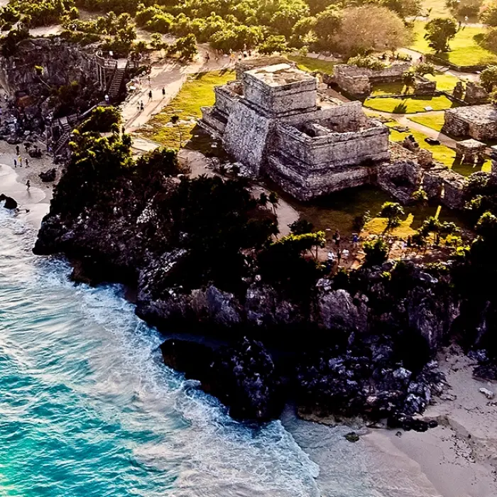 Drone shot of the Tulum archaeological site overlooking the Caribbean Sea, featured in the Tulum Xtreme Tour