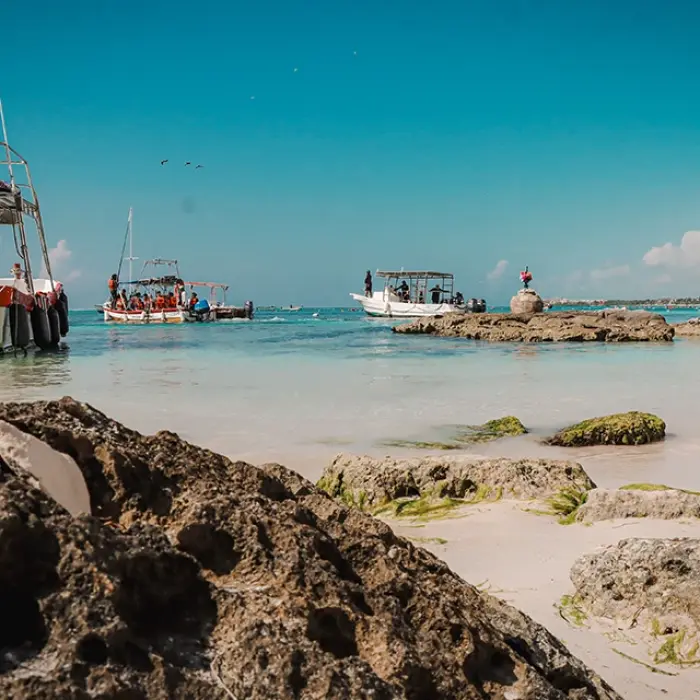 Akumal Bay scene: Boats anchored in the clear, shallow waters of Akumal Bay near the shore