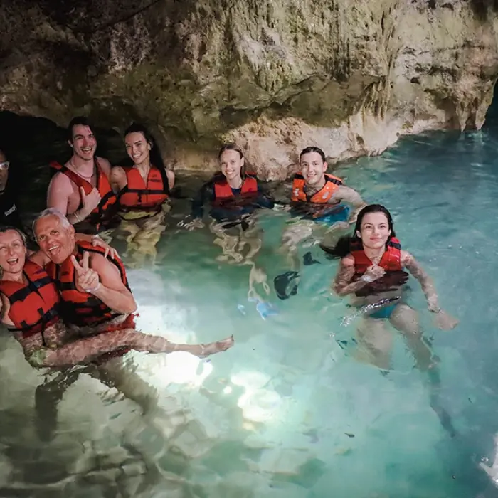 Cenote Yum Balam group: Smiling group of people in life vests enjoying the clear water of Cenote Yum Balam